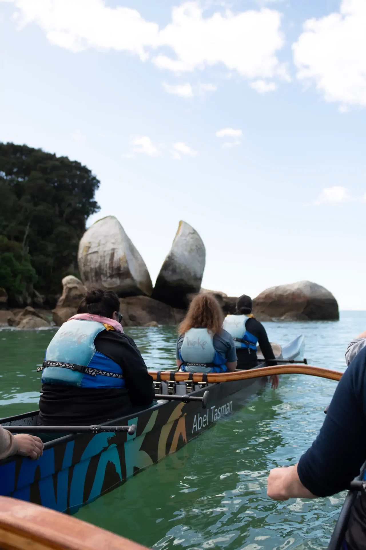 Double hull waka at Toku Ngawha (Split Apple Rock)